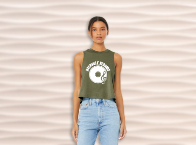 Woman wearing a sage green tank top decorated with Nashville Records logo Nashville, Tennessee.