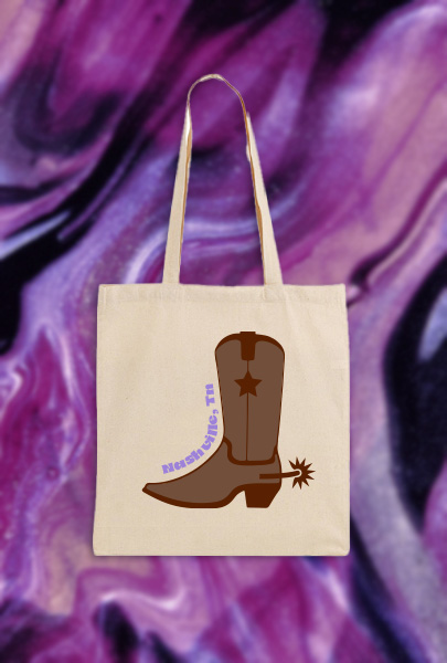 Cream canvas bag decorated with a cowboy boot graphic and Nashville, TN logo